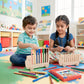 Two children playing with wooden toys in a colorful classroom setting.